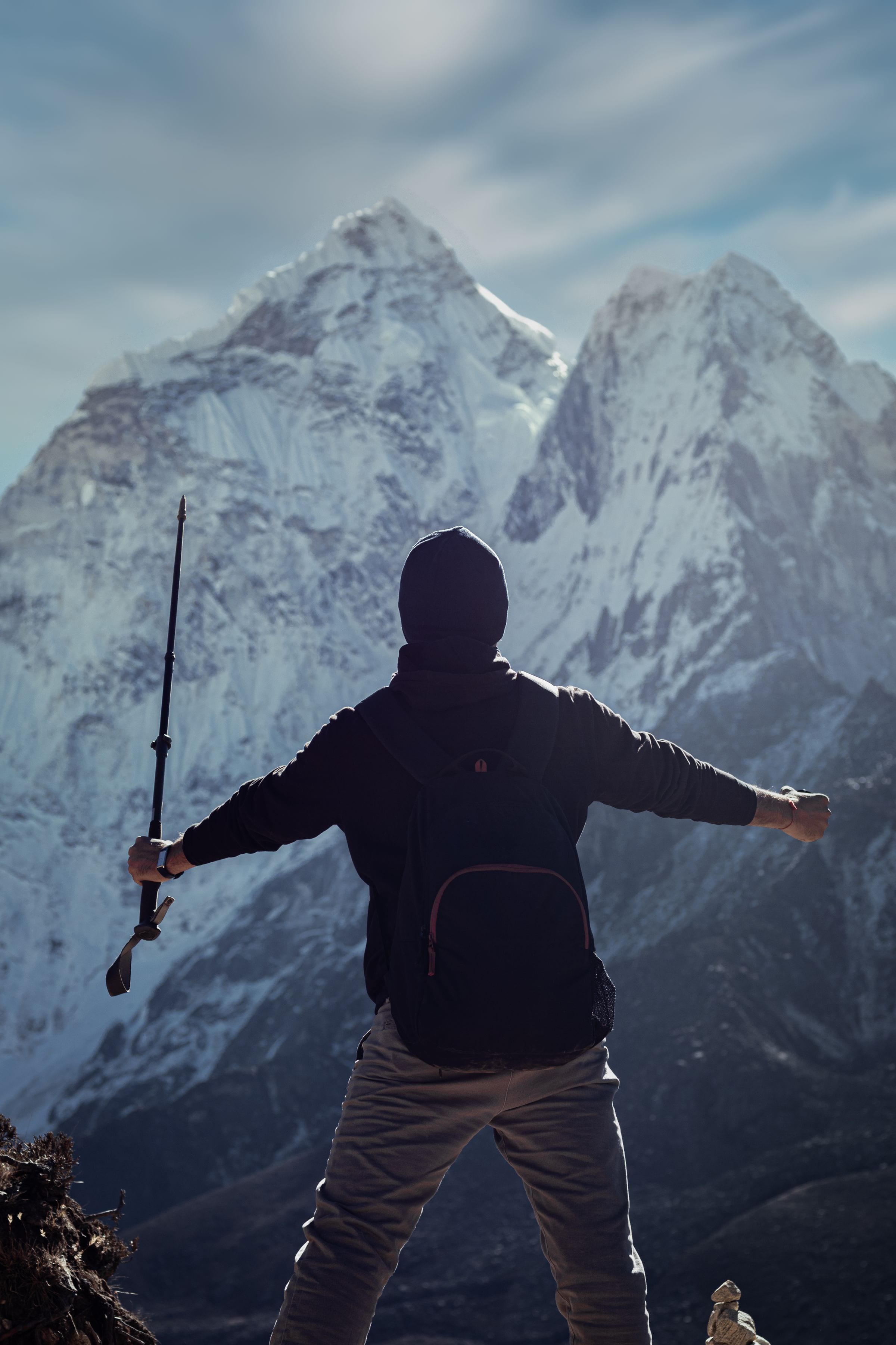 A trekker silhouetted against Ama Dablam above the village of Dingboche