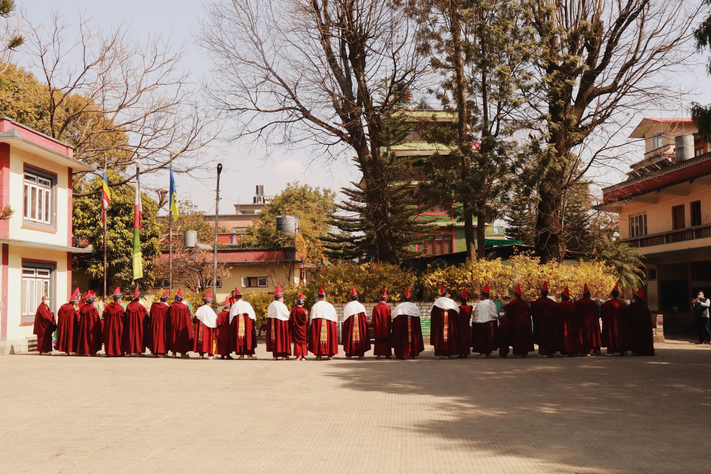 Monks assembled in the courtyard of a Himalayan monastery