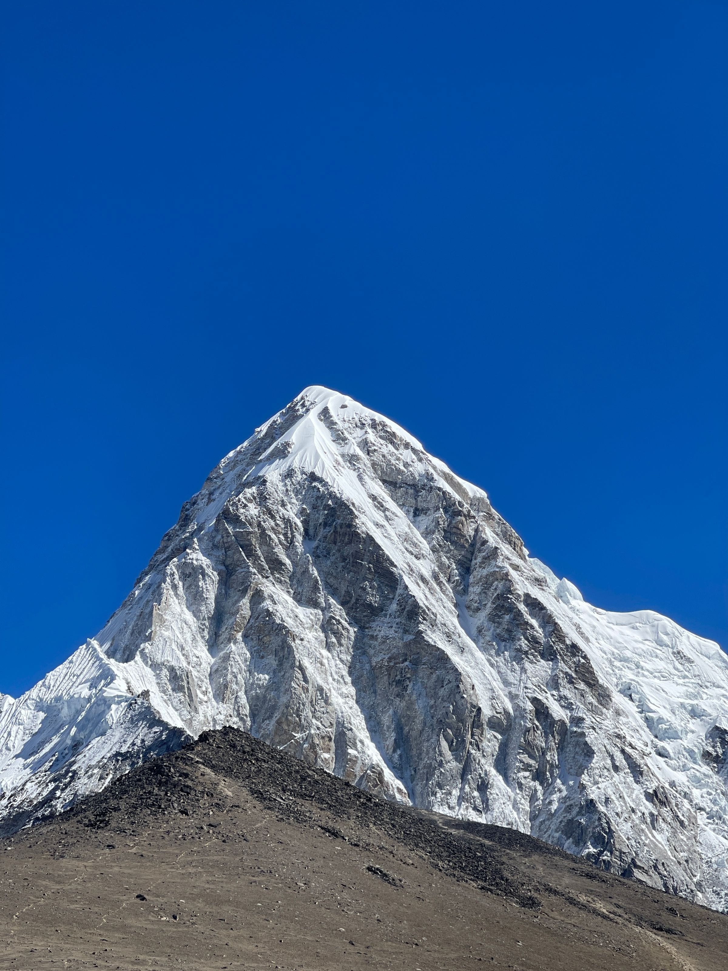 The pyramid summit of Pumori under a clear blue sky
