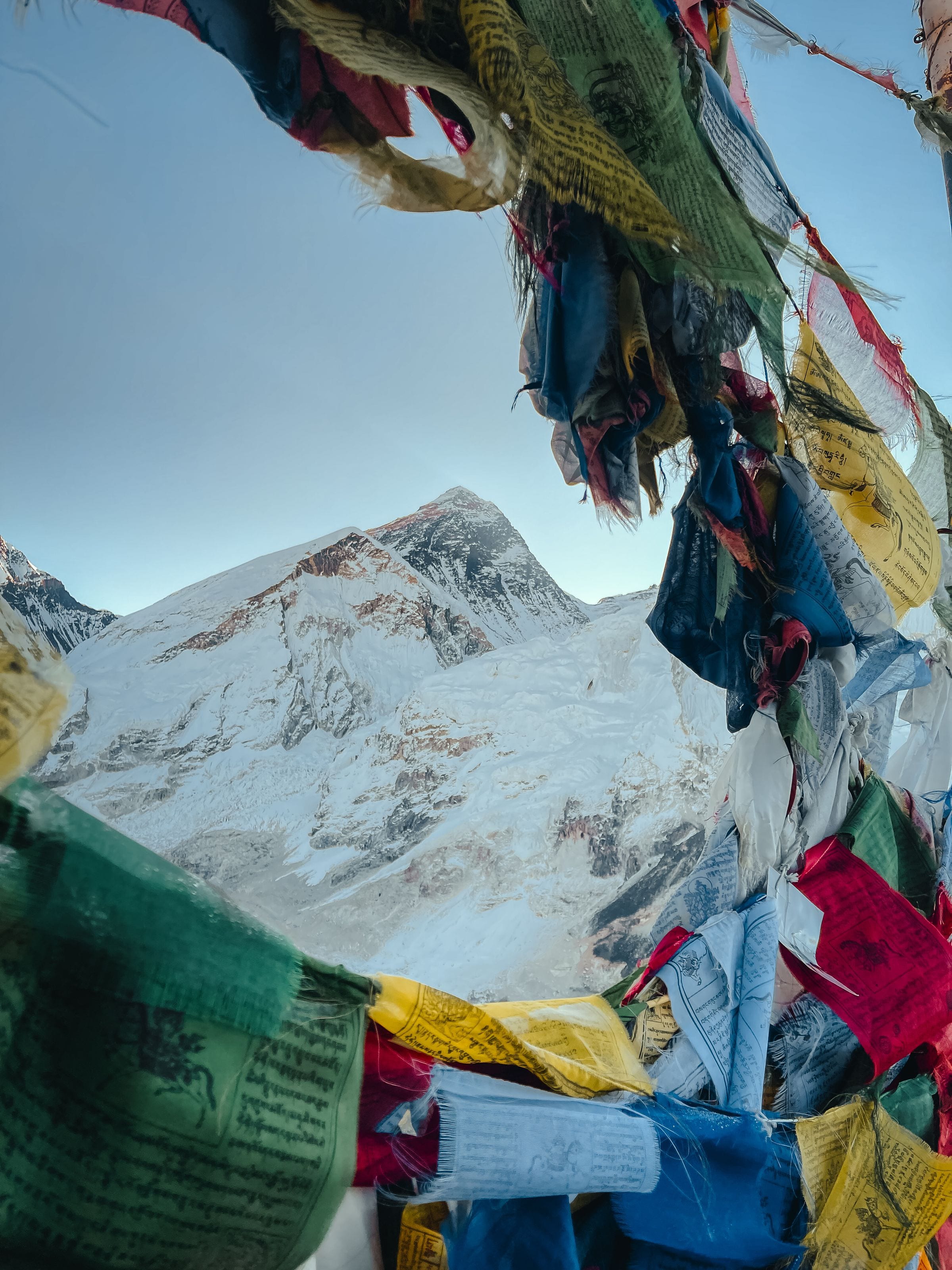 Mount Everest framed by lines of coloured prayer flags