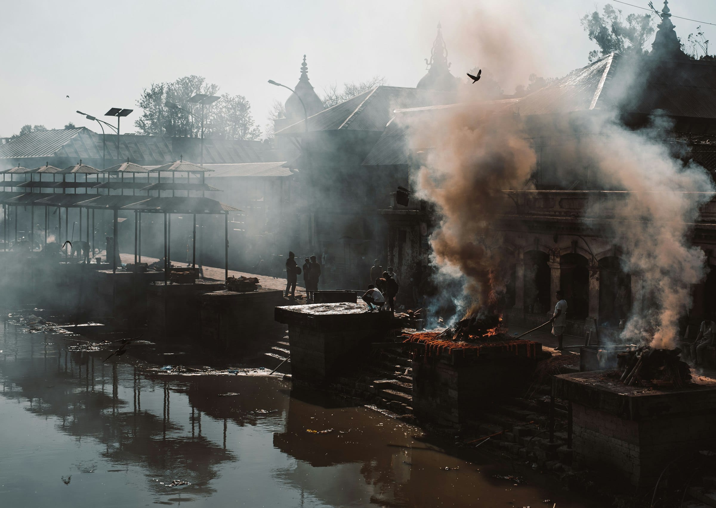 Smoke rising from the cremation ghats beside the Bagmati river