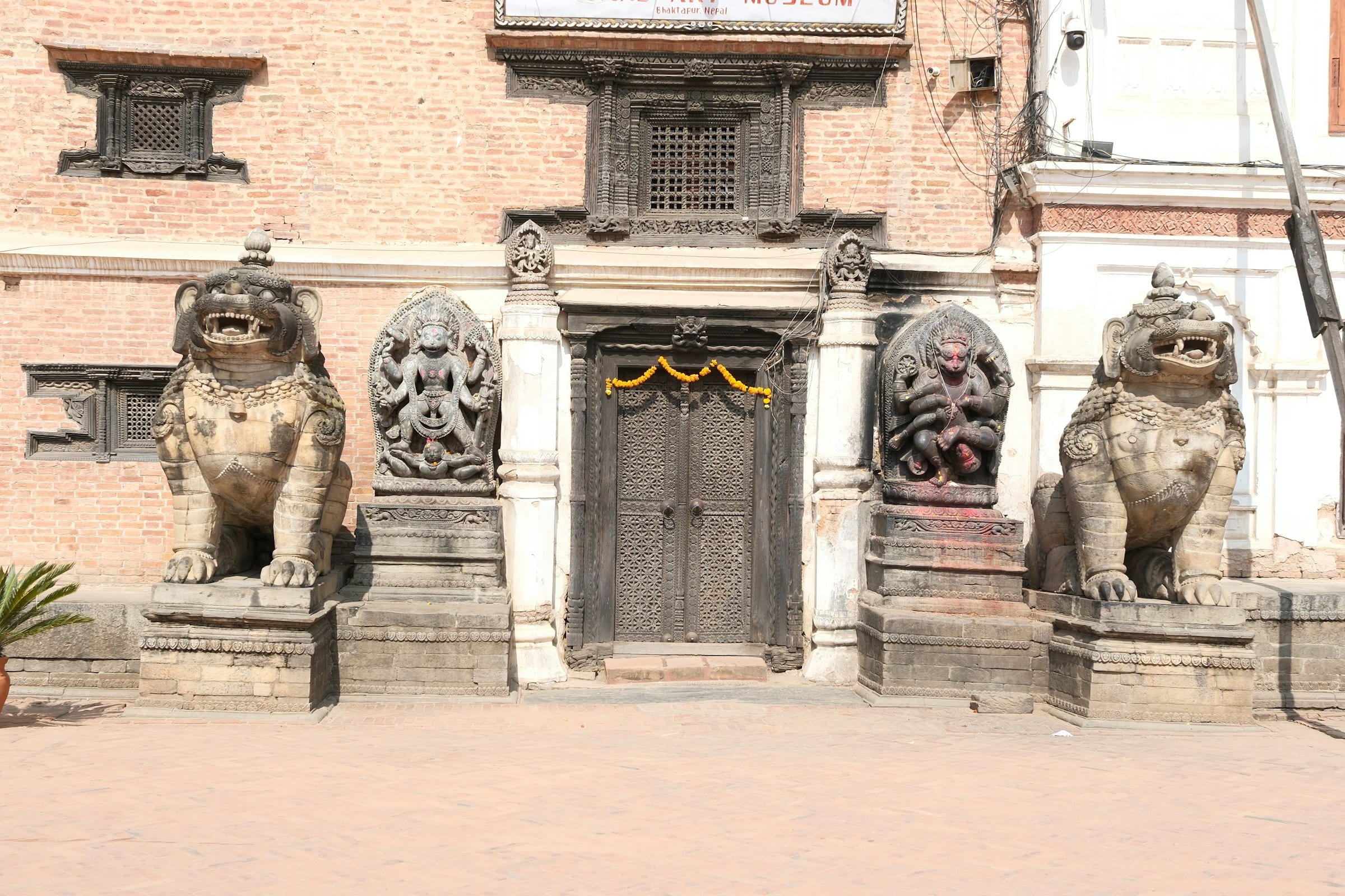 Stone guardian lions flanking a temple gate in Bhaktapur