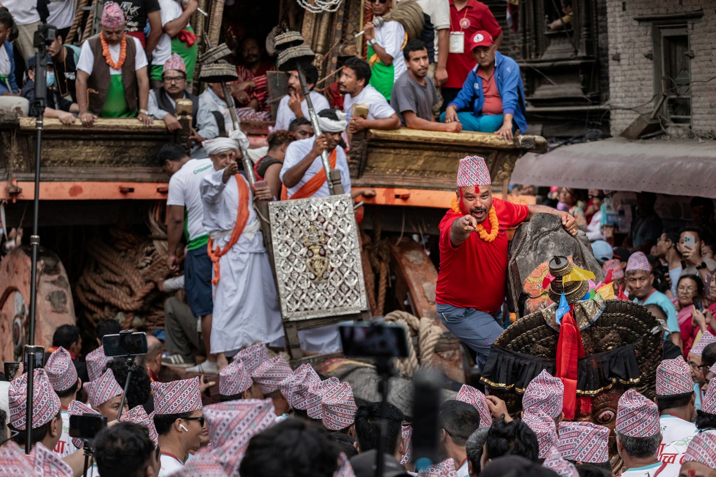 A festival procession in traditional dress through a valley town