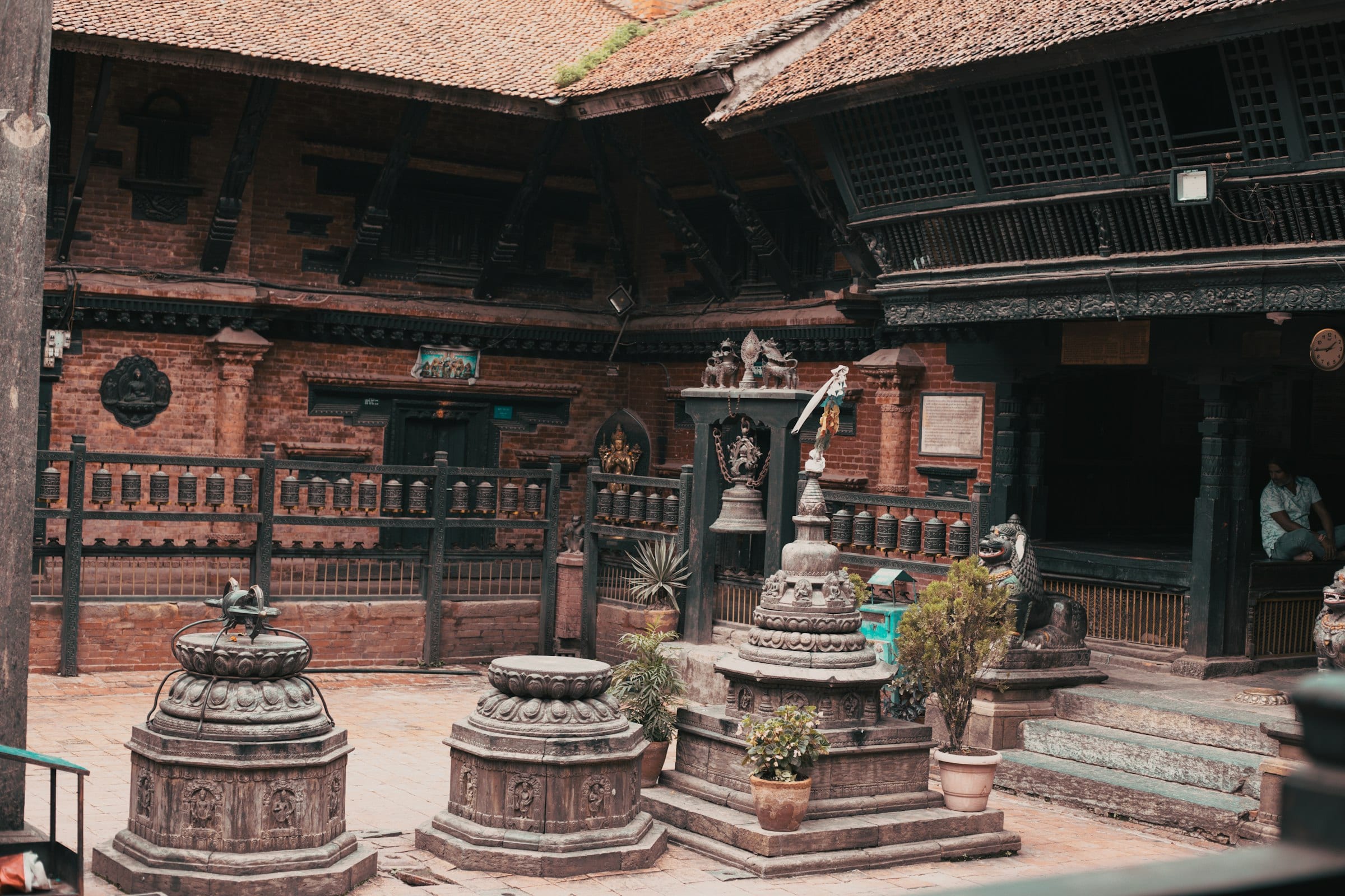 Small stone stupas in a brick monastery courtyard in Patan