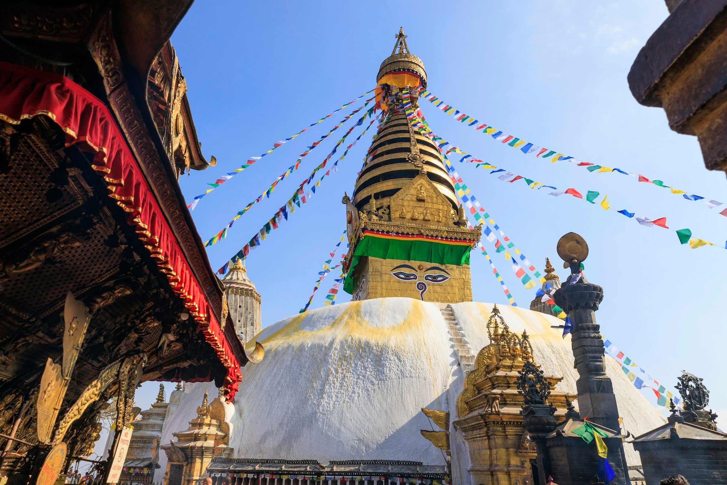 The gilded spire of Swayambhunath hung with prayer flags
