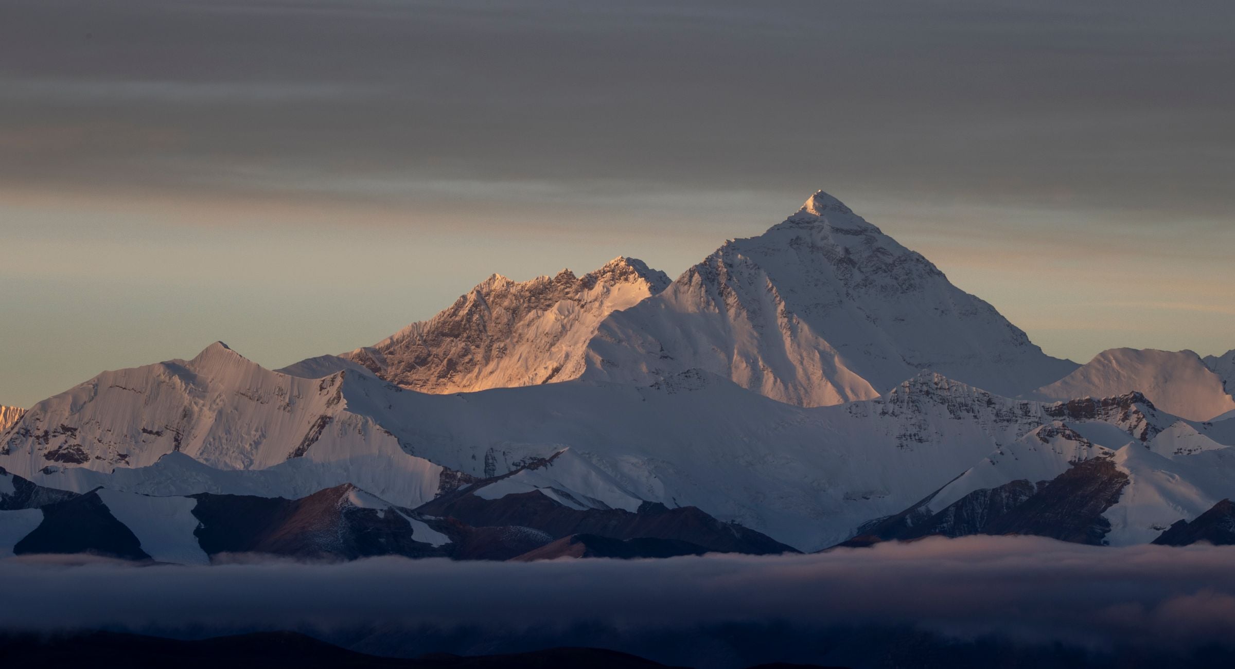 First light on a Himalayan summit standing clear of an empty dawn sky