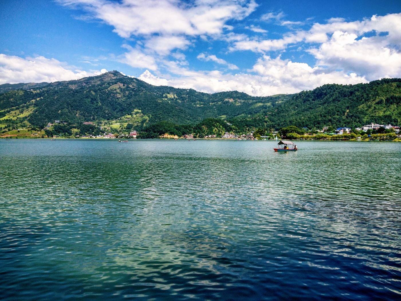 Wooden boats moored on Phewa Lake below the Annapurna range